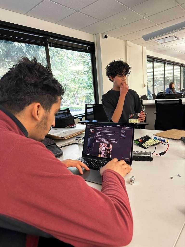 A student working on the team notebook on a laptop